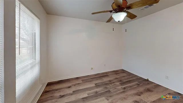 a view of a room with a fan and a window