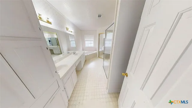 a view of a hallway with furniture and a window