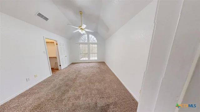 an empty room with windows and entrance