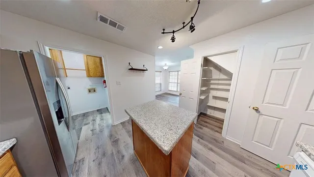 a view of a kitchen with furniture and wooden floor