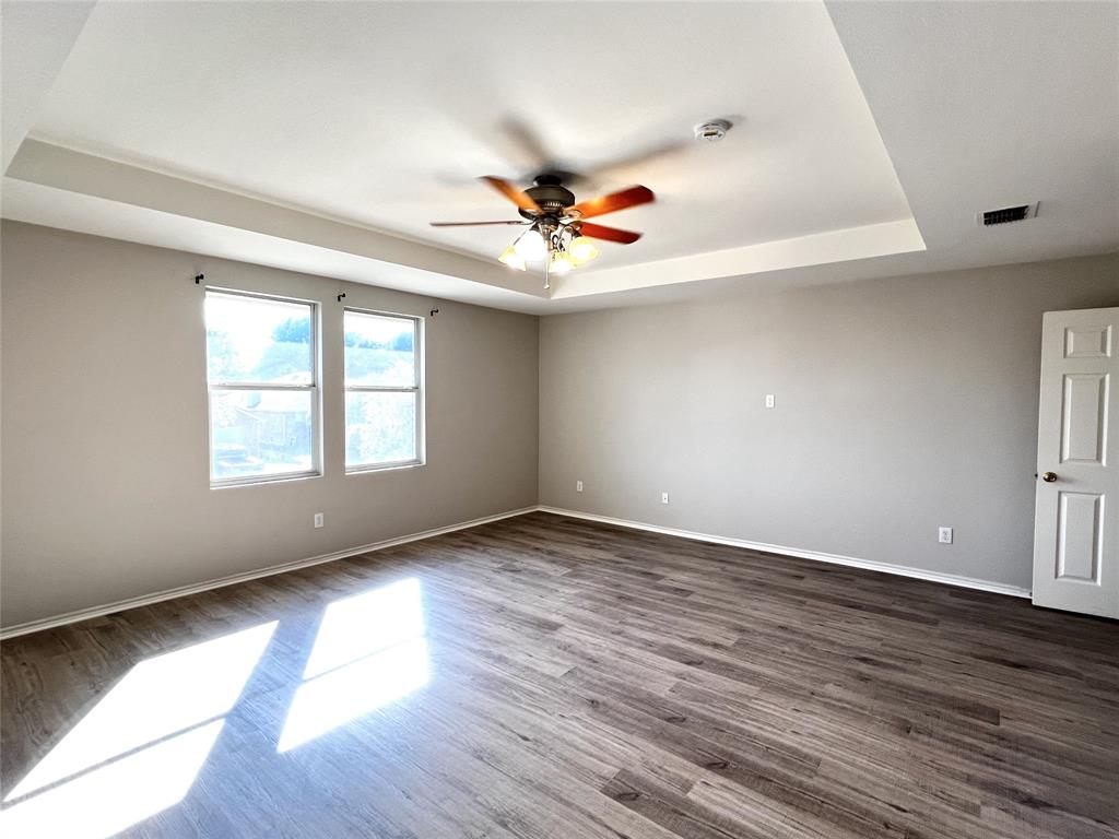 12864 Cowper Drive Frisco, TX 75035 - Photo 15 of 28 an empty room with wooden floor and windows