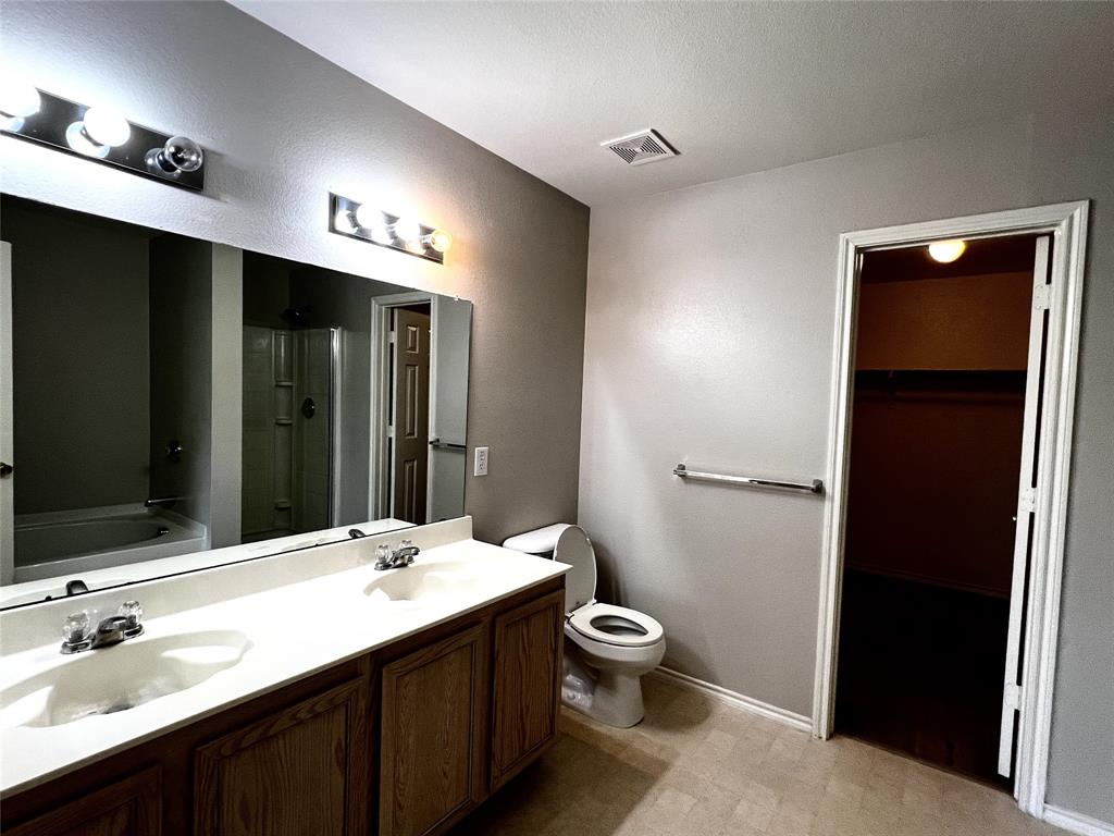 12864 Cowper Drive Frisco, TX 75035 - Photo 17 of 28 a bathroom with a double vanity sink toilet and mirror