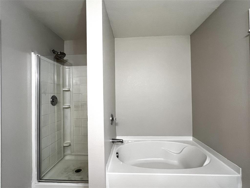 12864 Cowper Drive Frisco, TX 75035 - Photo 18 of 28 a white bath tub sitting next to a shower