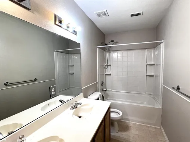 a bathroom with a bathtub and a sink