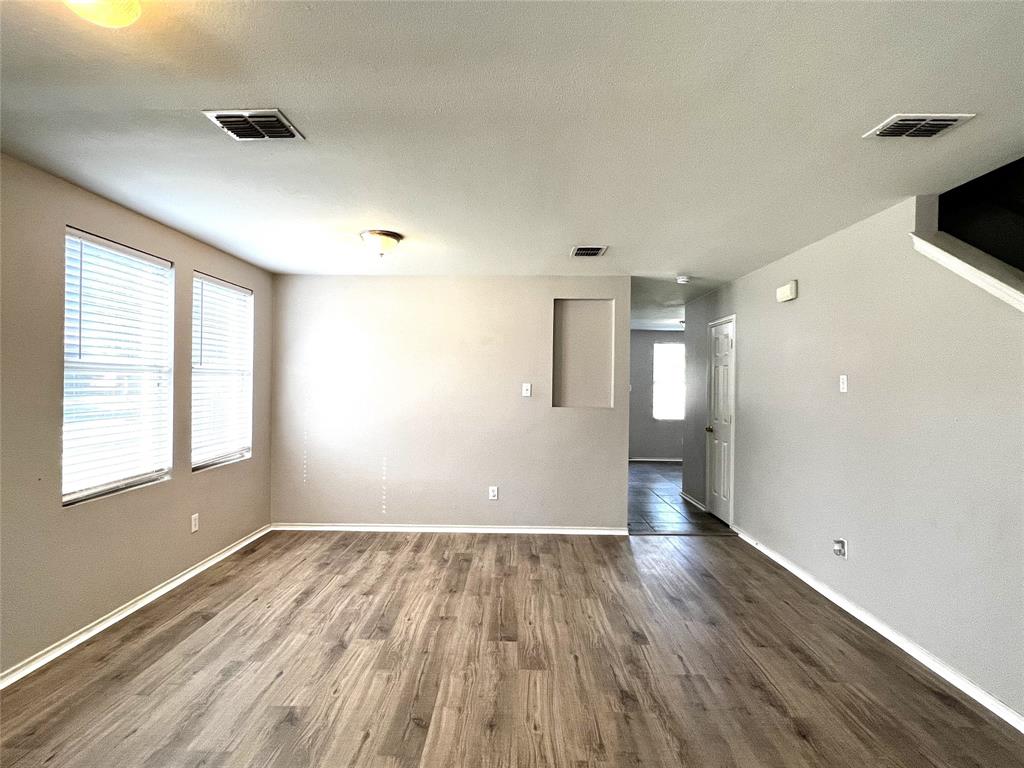 12864 Cowper Drive Frisco, TX 75035 - Photo 5 of 28 an empty room with wooden floor and windows