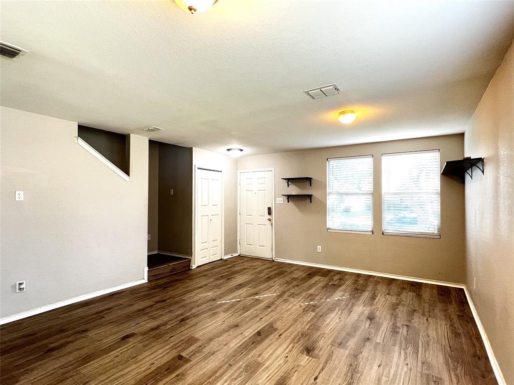 12864 Cowper Drive Frisco, TX 75035 - Photo 6 of 28 an empty room with wooden floor and windows