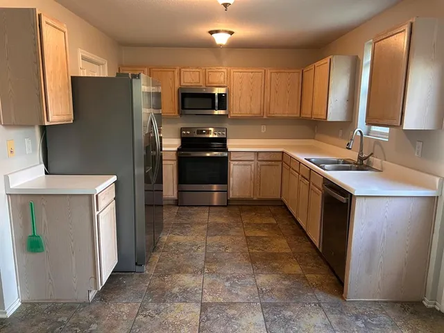 a kitchen with a sink stove and refrigerator