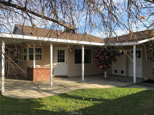 a view of a house with backyard porch and sitting area