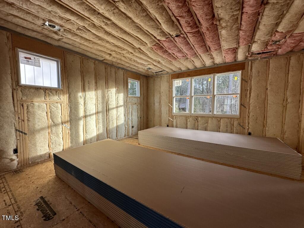 9408 Rawson Avenue Raleigh, NC 27613 - Photo 13 of 17 a bed sitting in a spacious bedroom next to a window