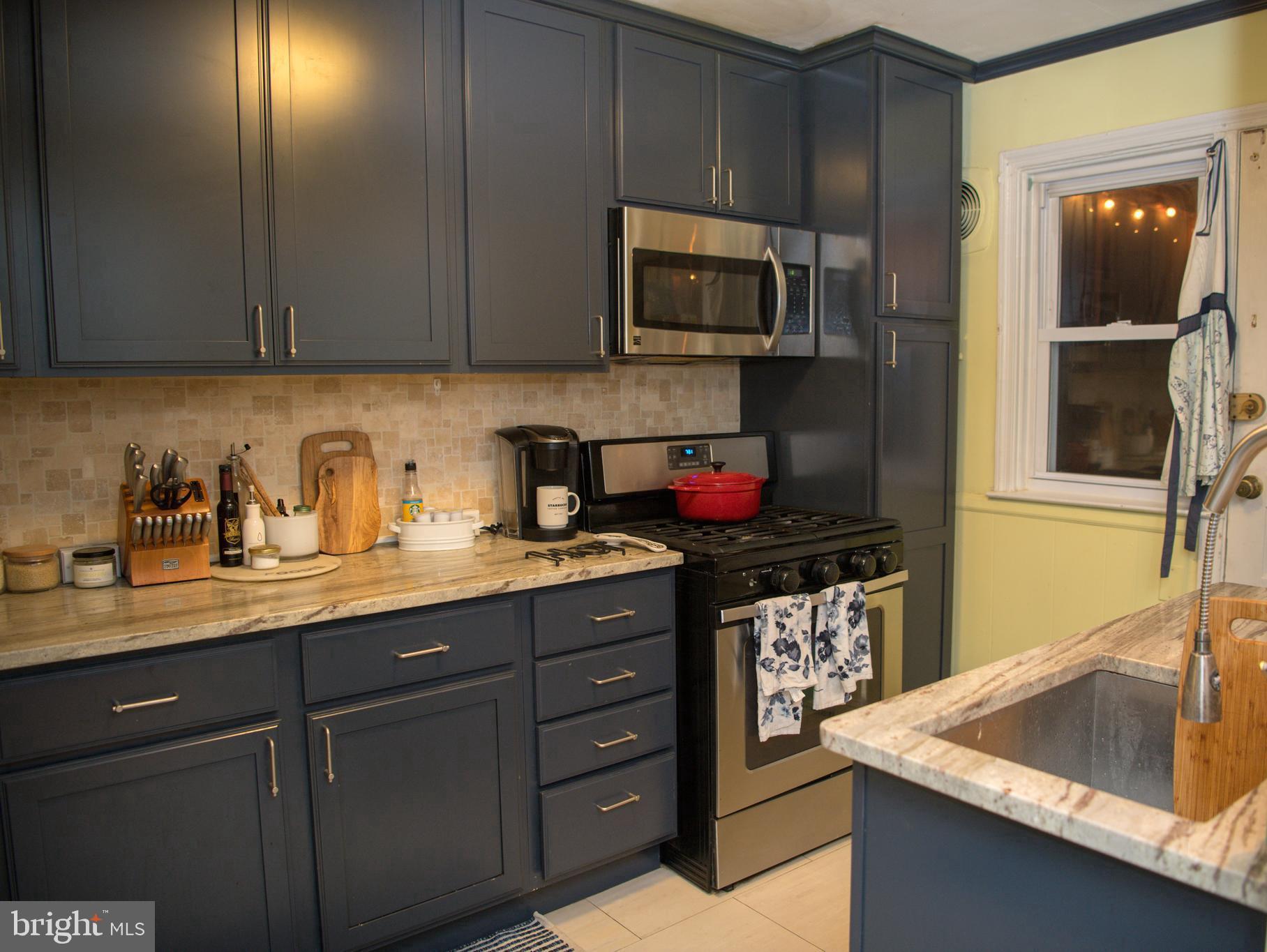 8637 Oak Road Baltimore, MD 21234 - Photo 4 of 18 a kitchen with stainless steel appliances granite countertop a sink stove and cabinets
