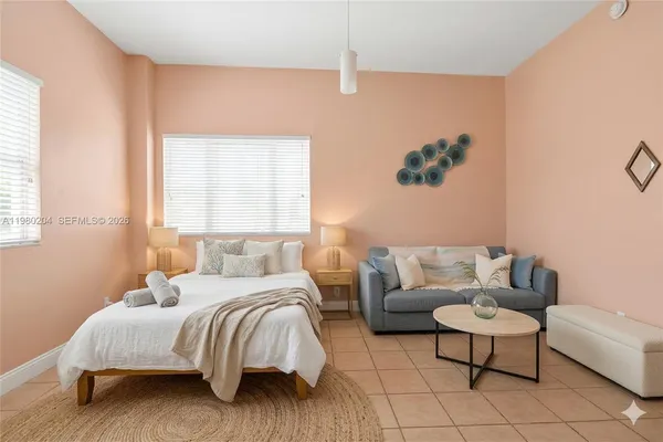 a bedroom with a bed and a couch