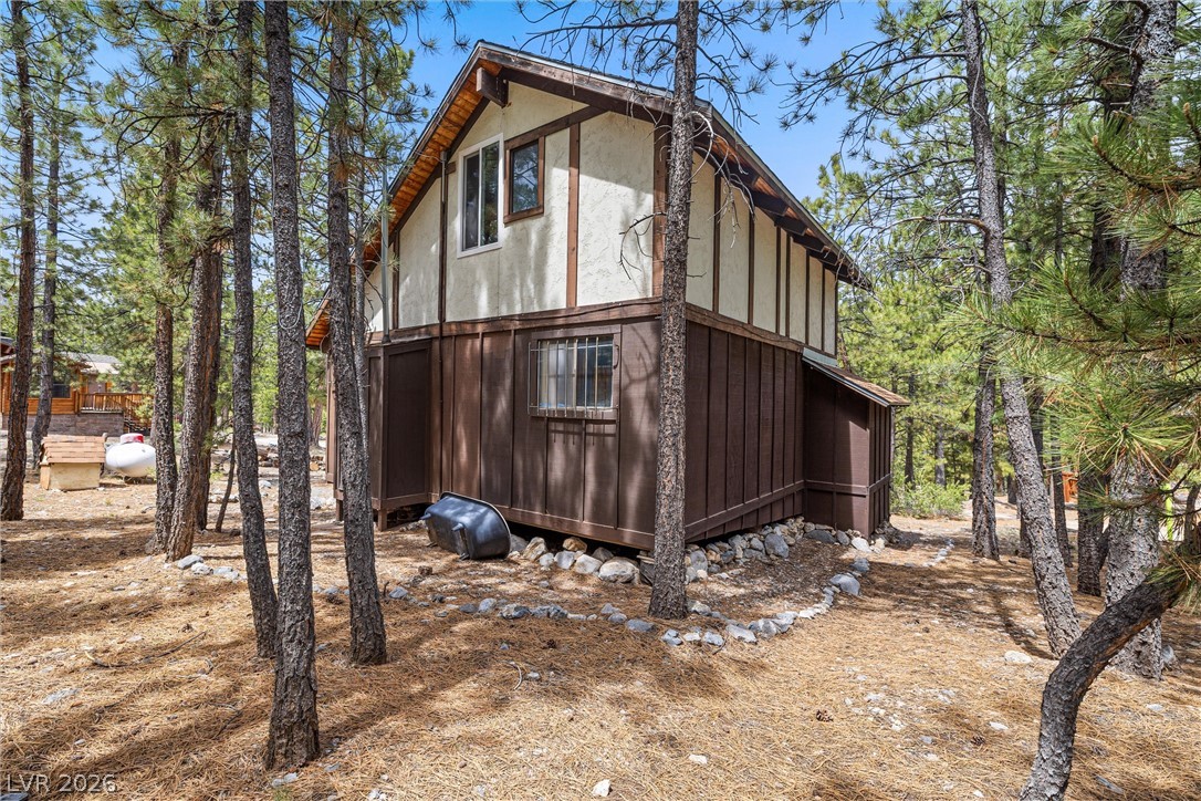 2146 Via Spes Nostra Street Mount Charleston, NV 89124 - Photo 5 of 33 A secluded cabin surrounded by towering pines offers a tranquil retreat amidst nature.