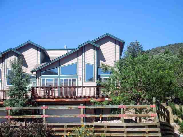 64 Pine Ridge Road, Unit 8 Basalt, CO 81621 - Photo 2 of 4 a front view of a house with balcony and trees in the background