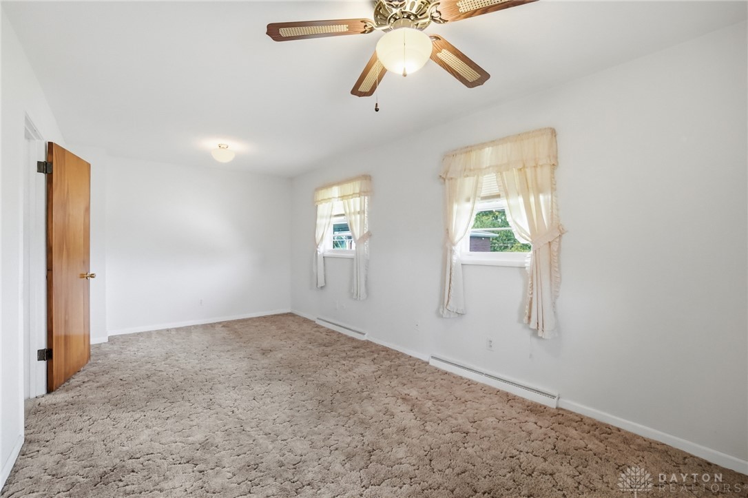 877 Woodhill Road Riverside, OH 45431 - Photo 15 of 42 This spacious bedroom offers ample natural light and a comfortable ambiance.