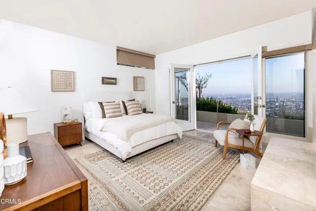 a bedroom with a bed and large window