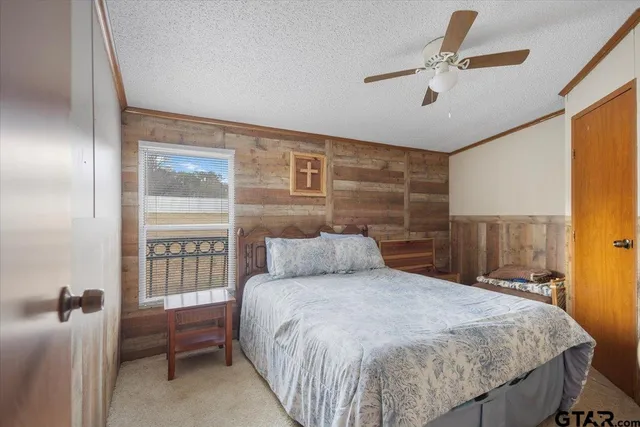 a bed room with a bed and a refrigerator