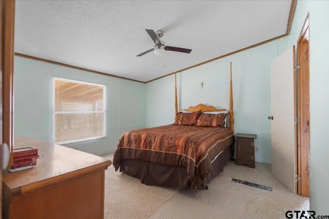 a bed sitting in a bedroom next to a window