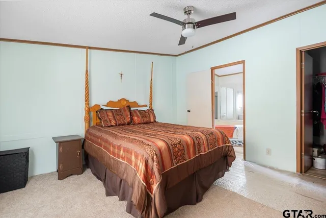 a bedroom with a bed and a television