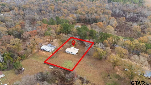 a living room with furniture kitchen view and a fireplace