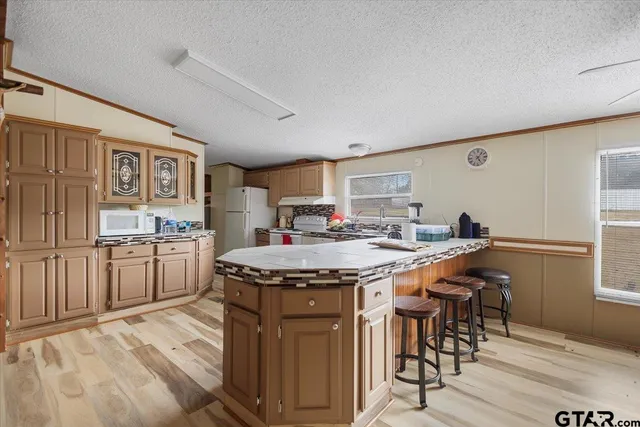 a kitchen with stainless steel appliances granite countertop a stove sink and cabinets