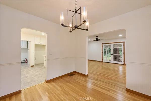 a kitchen with granite countertop white cabinets and stainless steel appliances