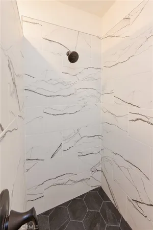 an empty room with wooden floor and ceiling fan