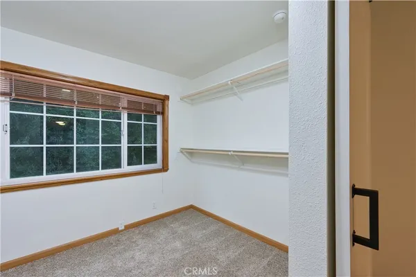 an empty room with a ceiling fan and a ceiling fan