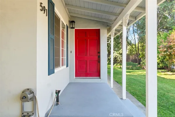 a view of empty room with window and wooden floor