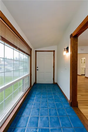 an empty room with wooden floor and a ceiling fan