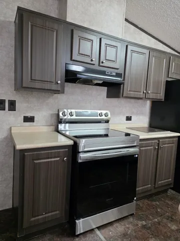 a kitchen with stainless steel appliances granite countertop a stove and a sink