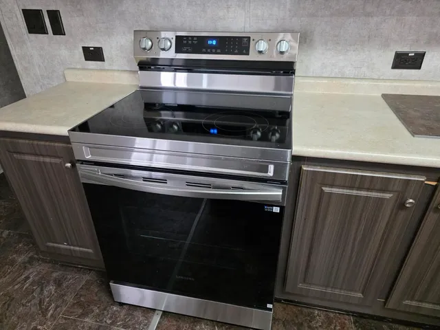 a stove top oven sitting inside of a kitchen