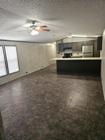 a kitchen with kitchen island a sink stainless steel appliances and cabinets