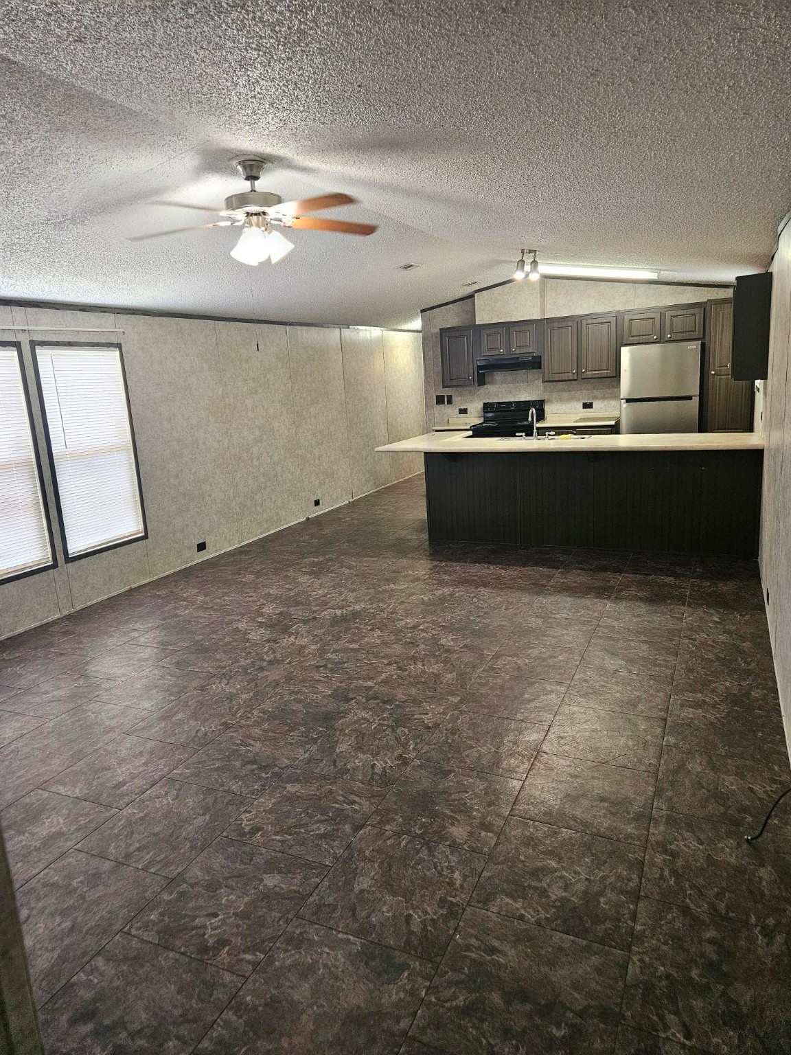 675 5604th Corner Cleveland, TX 77327 - Photo 5 of 13 a kitchen with kitchen island a sink stainless steel appliances and cabinets