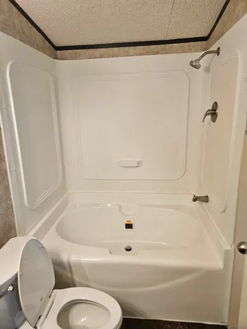 a bathroom with a tub and a shower