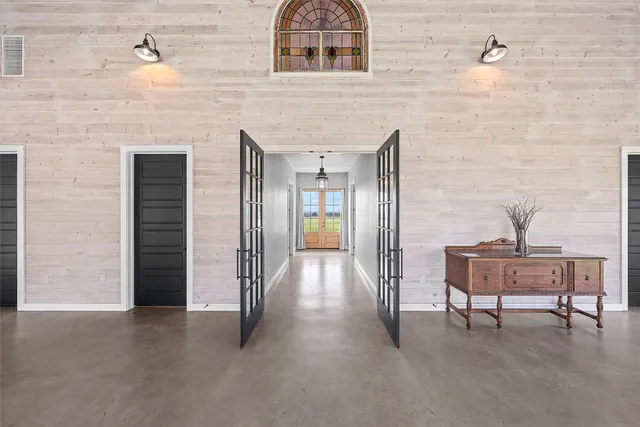 a view of gallery with wooden floor and dining room