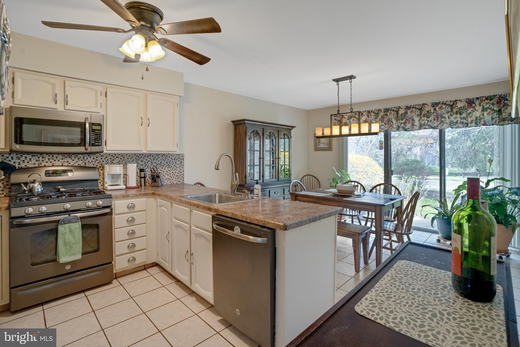 806 Kings Croft Drive Cherry Hill, NJ 08034 - Photo 6 of 31 a kitchen with stainless steel appliances granite countertop a stove top oven a sink a counter space and cabinets