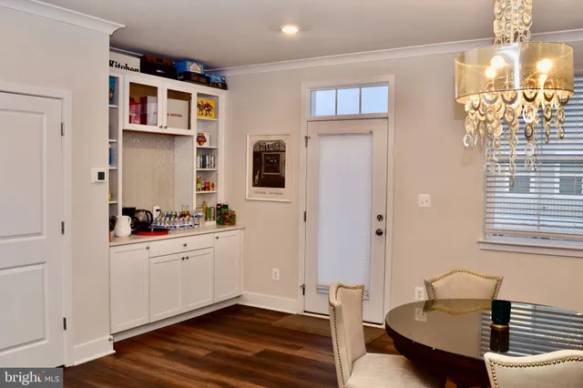 a view of a dining room with furniture wooden floor and chandelier
