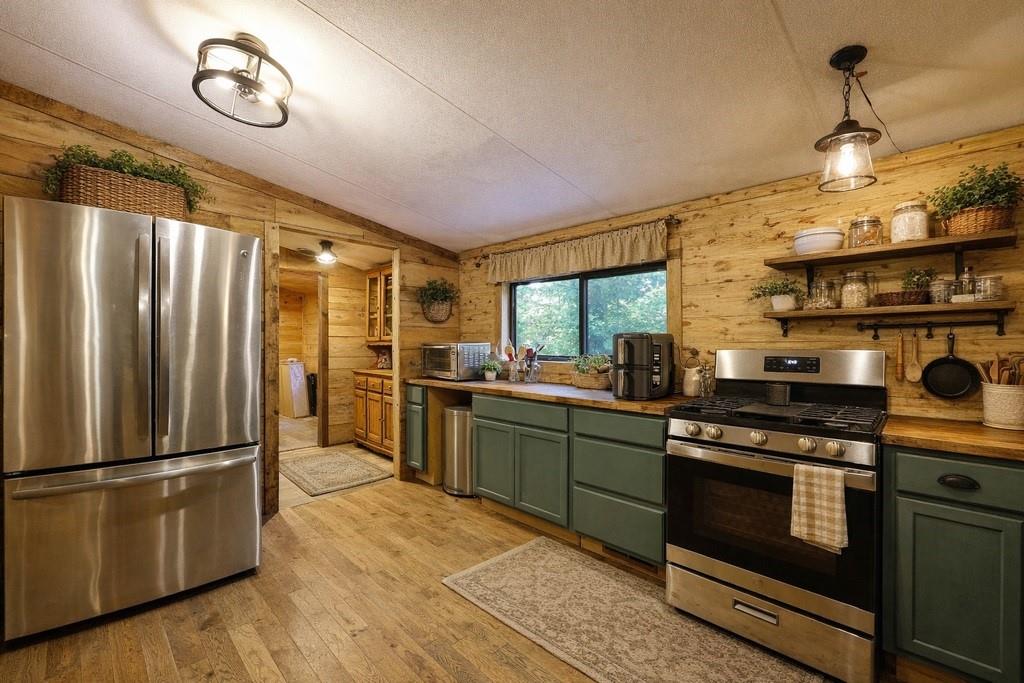 192 Bushy Head Road Cherry Log, GA 30522 - Photo 13 of 13 a kitchen with stainless steel appliances granite countertop a stove a refrigerator and a view of living room