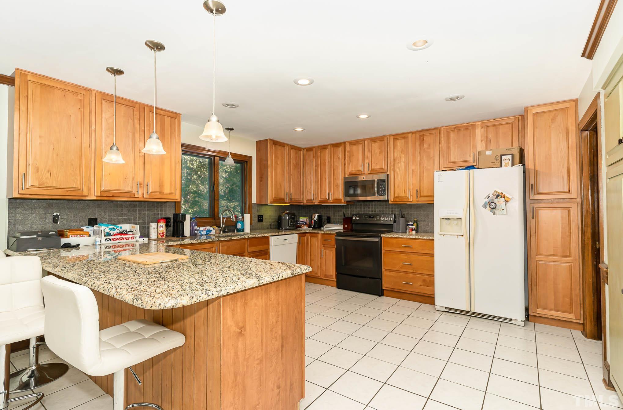 8700 Stage Ford Road Raleigh, NC 27615 - Photo 13 of 25 a kitchen with refrigerator a stove and a refrigerator