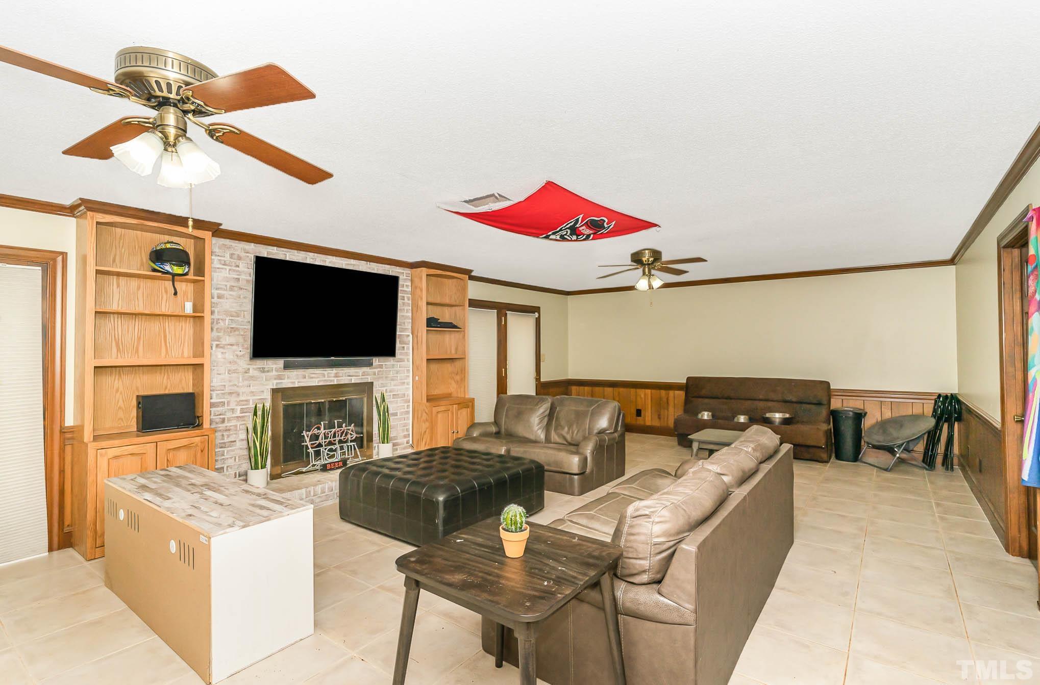 8700 Stage Ford Road Raleigh, NC 27615 - Photo 16 of 25 a living room with furniture and a flat screen tv