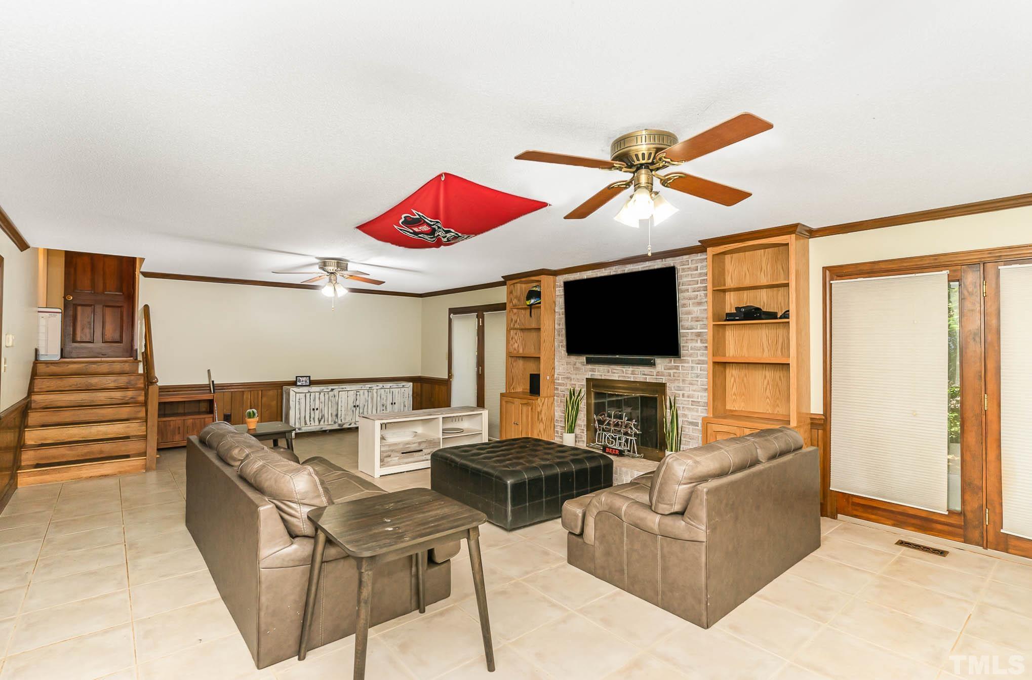 8700 Stage Ford Road Raleigh, NC 27615 - Photo 17 of 25 a living room with furniture a flat screen tv and a fireplace