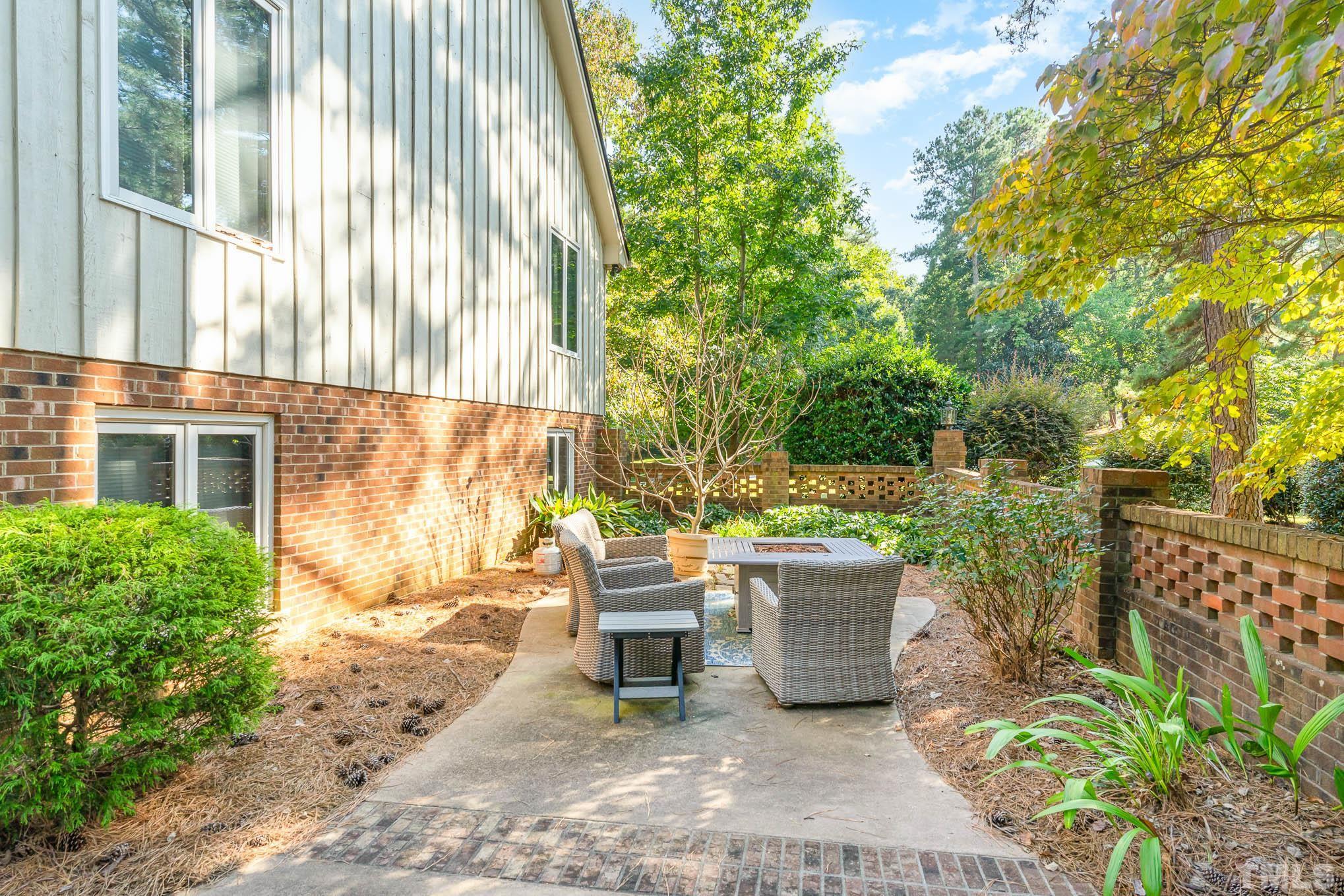 8700 Stage Ford Road Raleigh, NC 27615 - Photo 3 of 25 a view of a patio with a table and chairs and potted plants