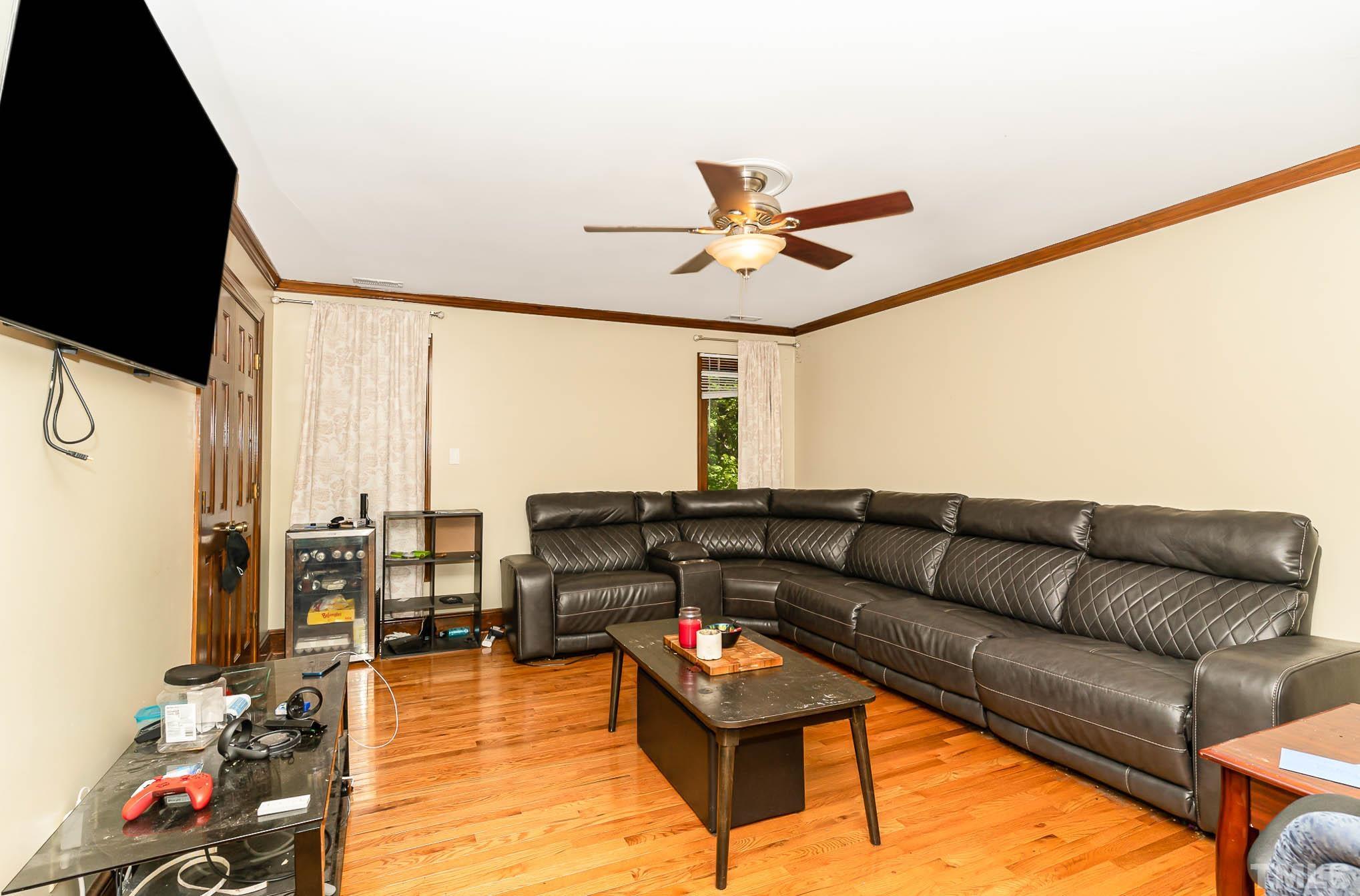 8700 Stage Ford Road Raleigh, NC 27615 - Photo 9 of 25 a living room with furniture and a flat screen tv