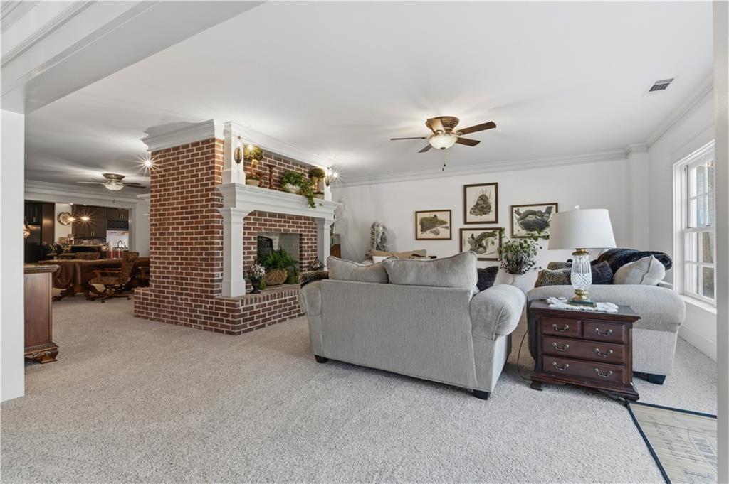 31 Duck Pond Road Roopville, GA 30170 - Photo 102 of 136 a living room with furniture ceiling fan and a fireplace