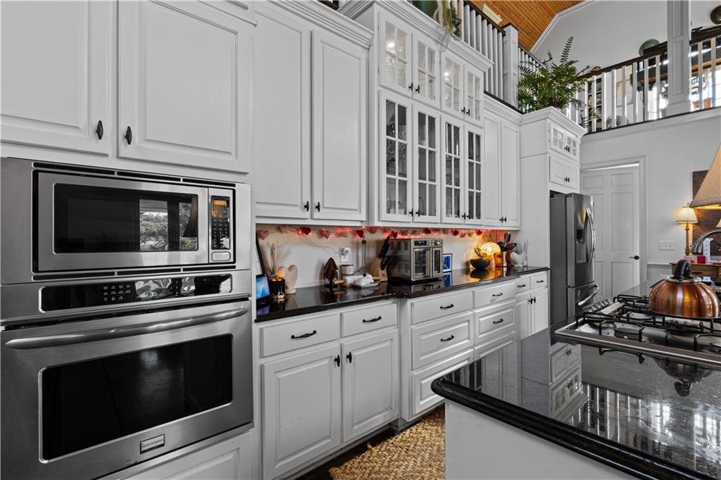 31 Duck Pond Road Roopville, GA 30170 - Photo 111 of 136 a kitchen with stainless steel appliances granite countertop a stove and cabinets
