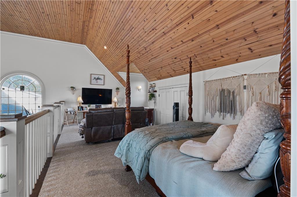 31 Duck Pond Road Roopville, GA 30170 - Photo 117 of 136 a bedroom with a large bed a flat tv screen and a dresser