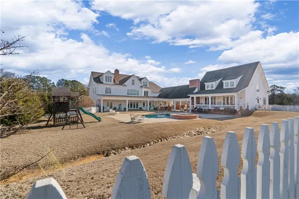 a view of a house with swimming pool and sitting area
