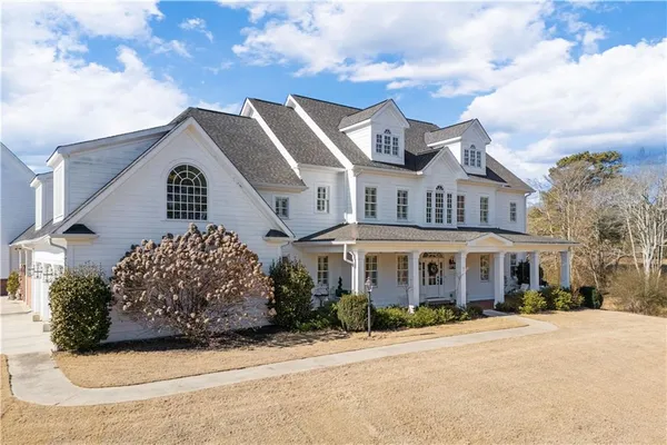 a front view of a house with a garden