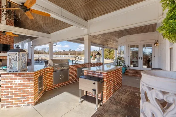 a kitchen with stainless steel appliances kitchen island granite countertop a stove and a refrigerator