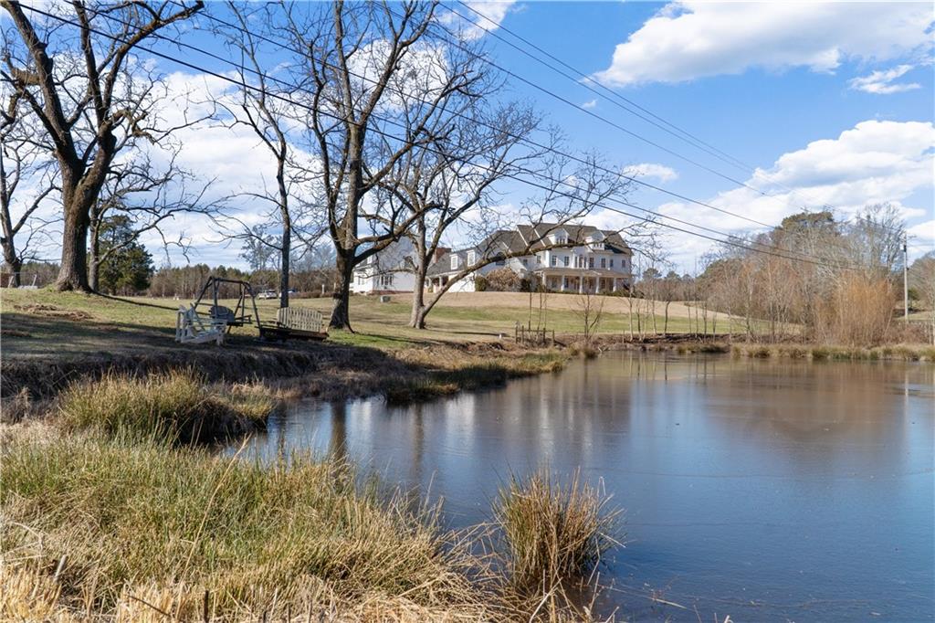 31 Duck Pond Road Roopville, GA 30170 - Photo 27 of 136 a view of a lake with houses covered with lake
